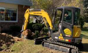 Excavator in yard working on water lateral line.